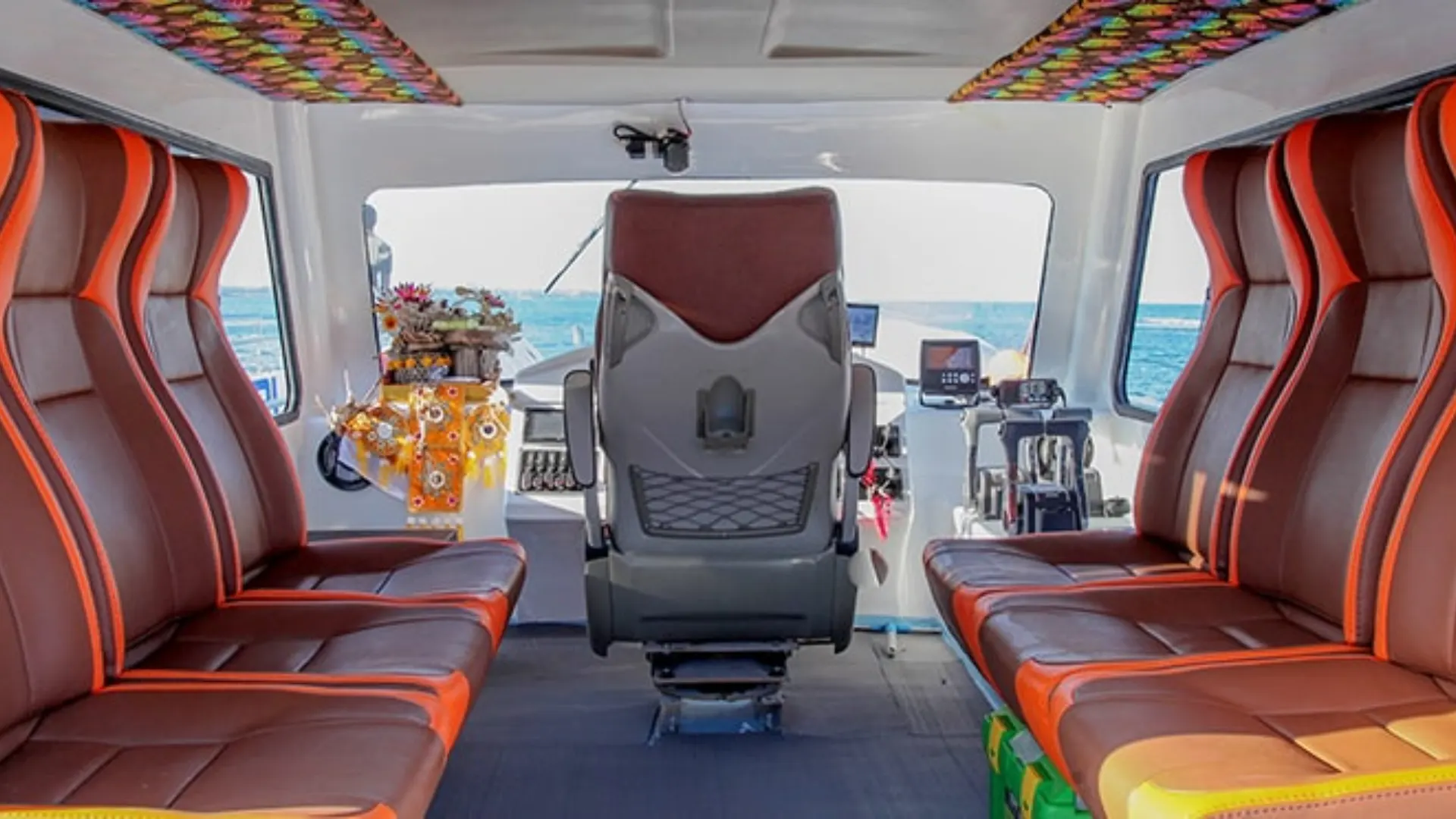 Passenger seating area near the captain on Dcamel Fast Boat offering a comfortable front cabin experience
