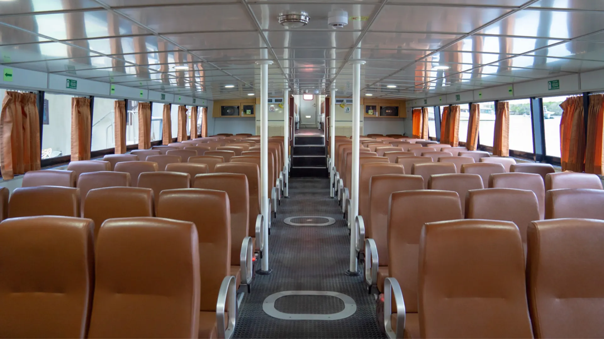 Interior of Eka Jaya Fast Ferry with comfortable padded seats and air conditioning front view cabin